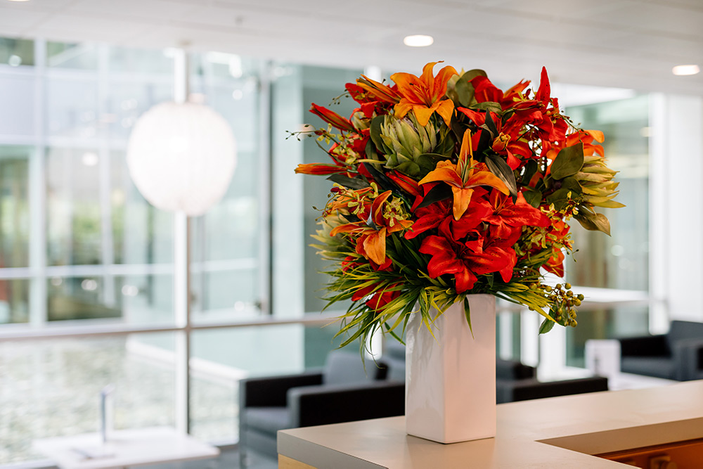 Modern orange artificial flower arrangement in reception