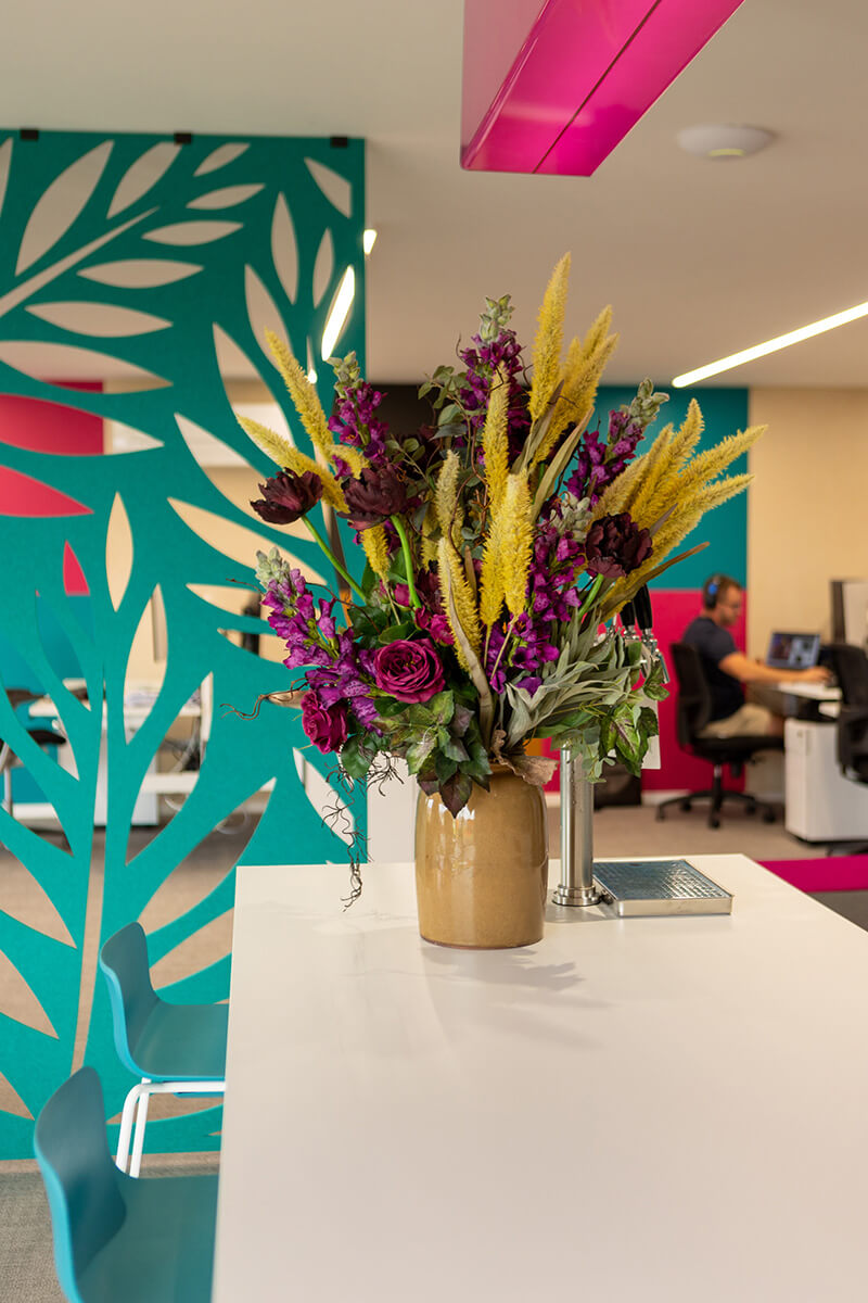 Purple and yellow flower arrangement placed in modern office